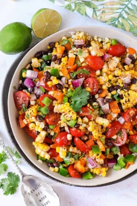 bowl of Black Bean and Corn Salad with limes