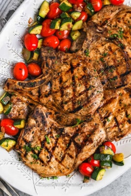 cooked Grilled Pork Chops with vegetables on a plate