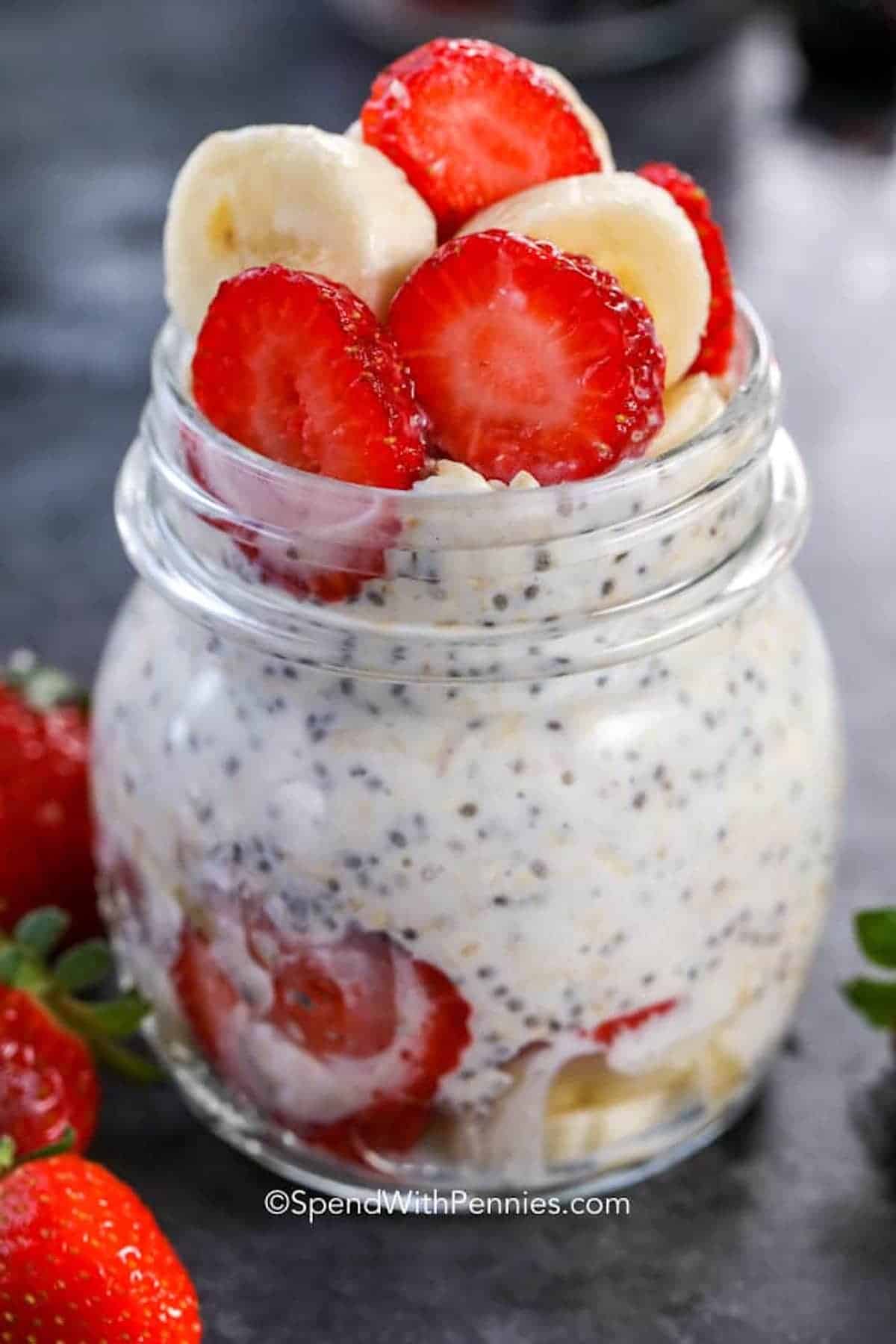 a jar of overnight oats with bananas and strawberries