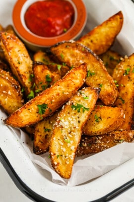 Air Fryer Potato Wedges topped with parsley and parmesan cheese
