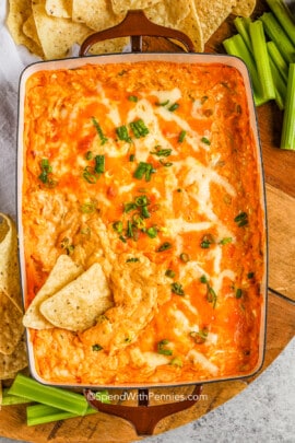 baked buffalo chicken dip with tortilla chips and celery
