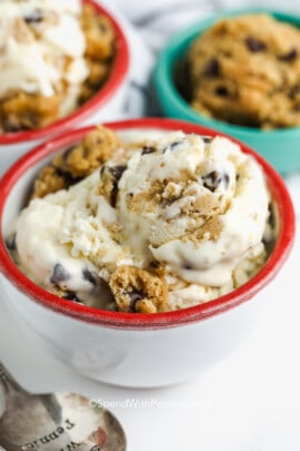 a bowl of homemade cookie dough ice cream with cookie dough in the background