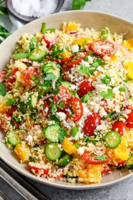 A prepared couscous salad with tomatoes and cucumbers