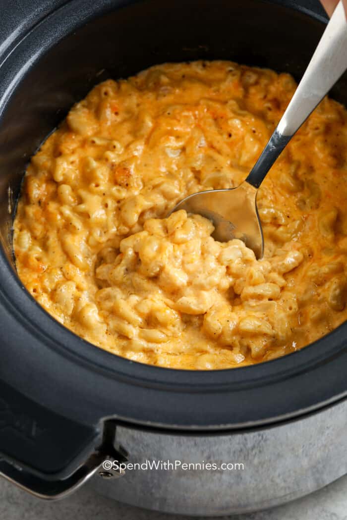 Crock Pot Mac and Cheese being served from a crockpot
