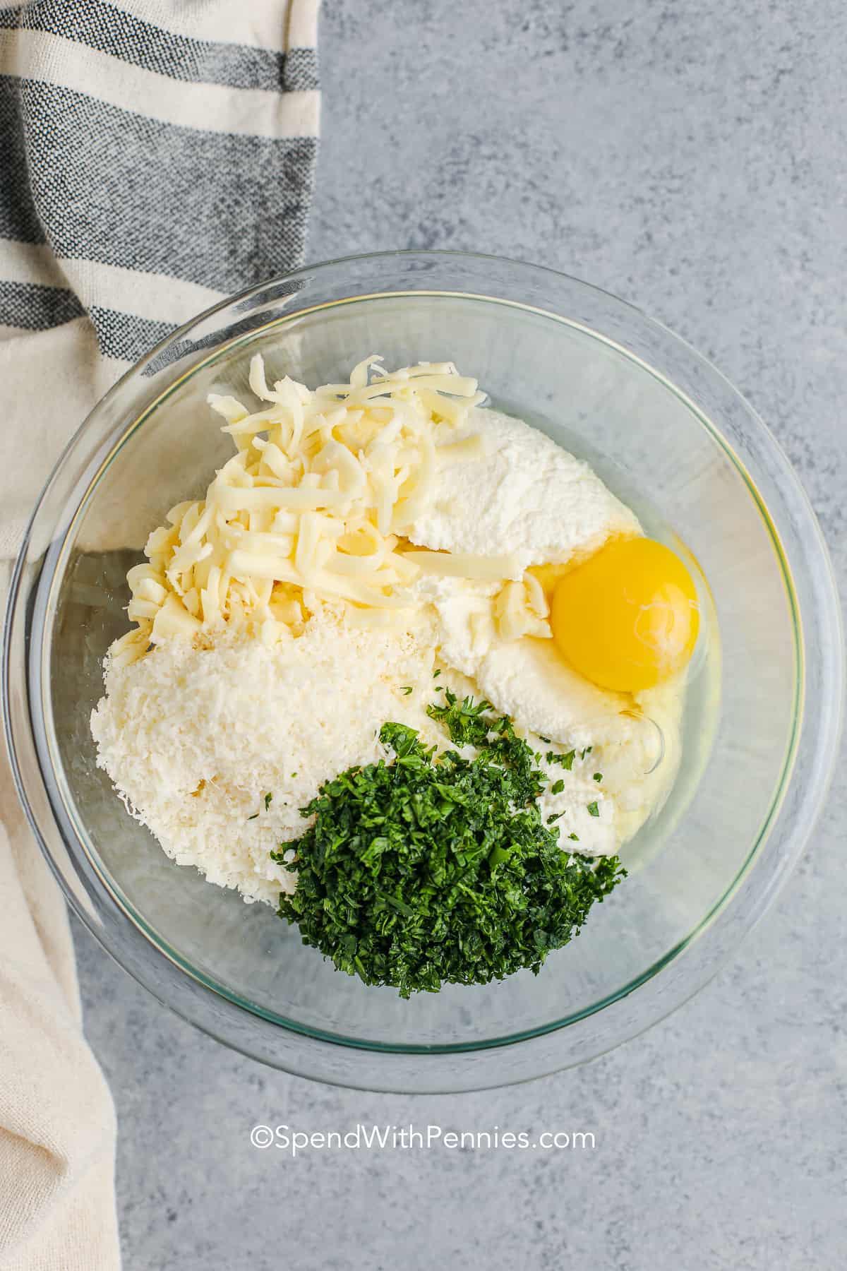 ricotta cheese mixture with an egg in a glass bowl for lasagna