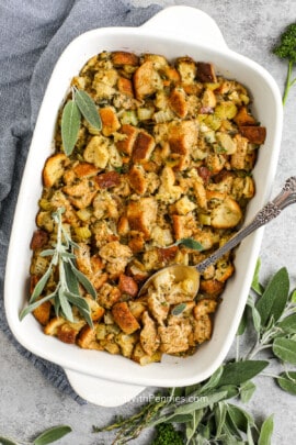 stuffing in a pan with herbs and a spoon