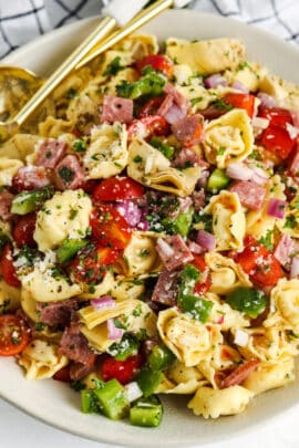 close up of Italian Tortellini Salad on a plate with a spoon and fork