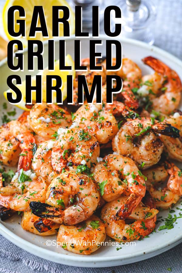 Garlic Grilled Shrimp on a plate with lemon shown with a title