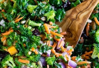 Easy Kale Salad in a bowl with a serving spoon