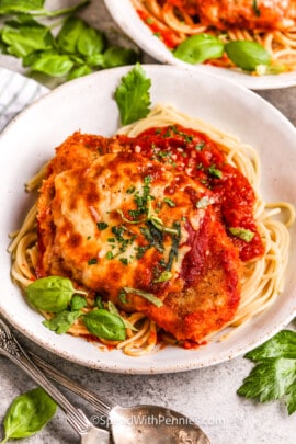 a homemade chicken parmesan recipe in a bowl with spaghetti