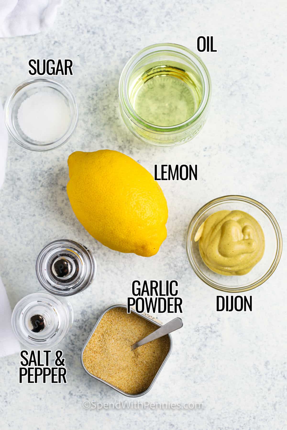 sugar , oil , lemon dijon , garlic powder , salt and pepper with labels to make Easy Dijon Vinaigrette