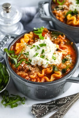 lasagna soup topped with ricotta cheese and herbs