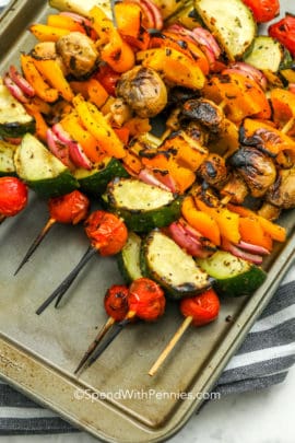 Marinated Grilled Vegetable Skewers piled up on a baking tray
