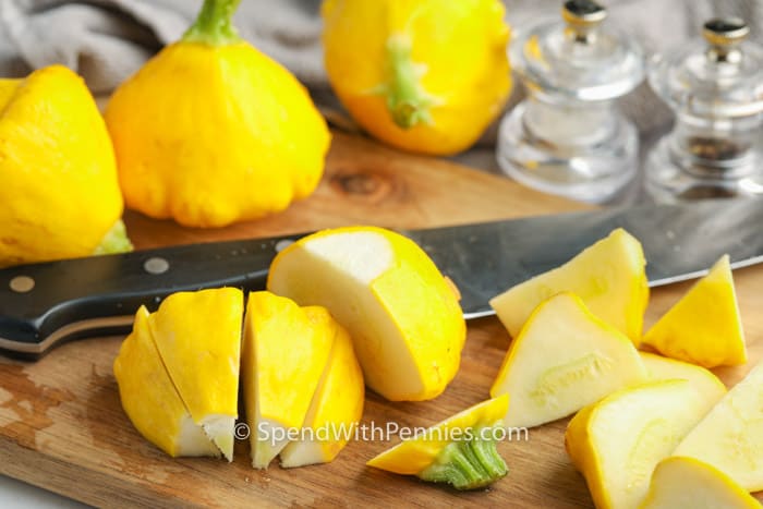 cutting up squash to make Roasted Patty Pan Squash with Herb Oil
