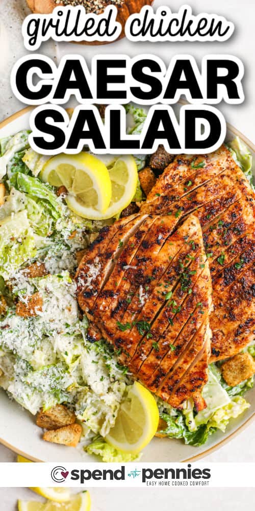 Grilled Chicken Caesar Salad with lemon wedges and writing