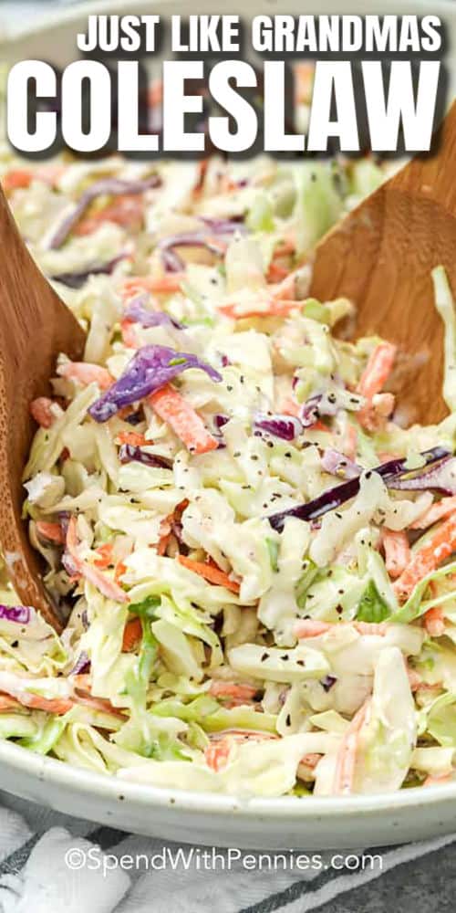 Coleslaw in a white bowl with spoons and writing