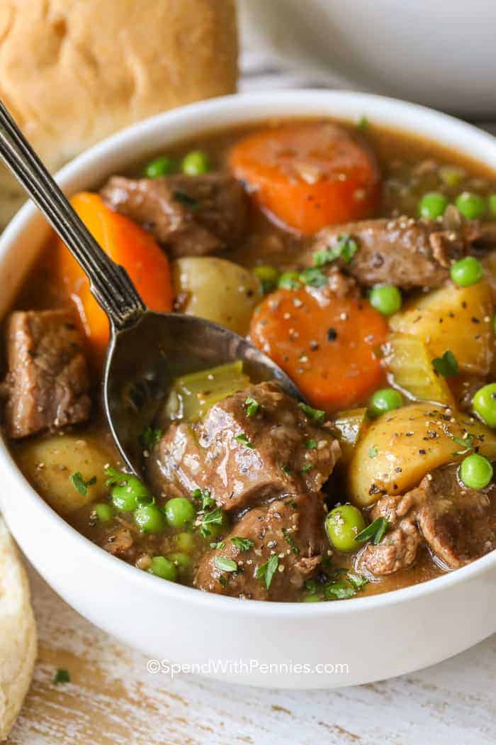 White bowl of Homemade Beef Stew with a spoon