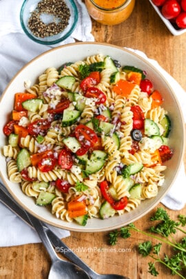 an an easy pasta salad in a white serving bowl with parsley