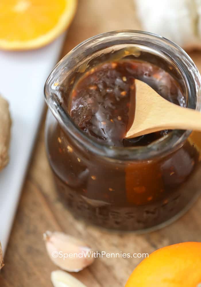 Wooden spoon in a glass jar of teriyaki sauce